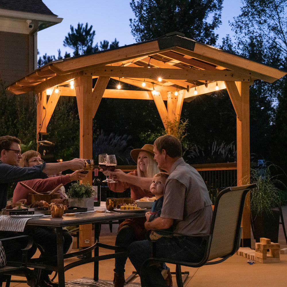 Load image into Gallery viewer, Family dinner party next to Granada Grill Gazebo
